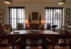 Outburst Threatens Mayor’s Job Executive office with large wooden desk and flags