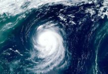 Hurricane Warnings Explode Across Coast Satellite view of a powerful hurricane swirling over the ocean