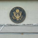 U.S. embassy seal on a building wall