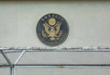 Red Sea Chaos Triggers Embassy Pullback U.S. embassy seal on a building wall