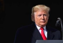 Election Clock Halts Iran Escalation Donald Trump at a podium with a microphone