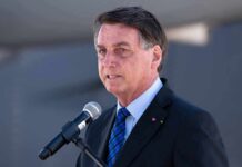 Fraud Claims CRUMBLE in Brazil man in suit speaking at a microphone