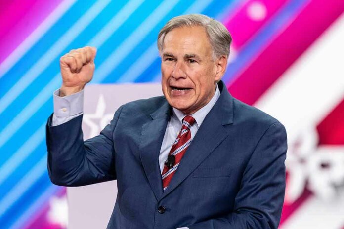 shutterstock_2188817459 man in suit speaking on stage with raised fist
