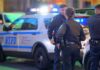 police officers standing near patrol vehicles