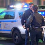 police officers standing near patrol vehicles