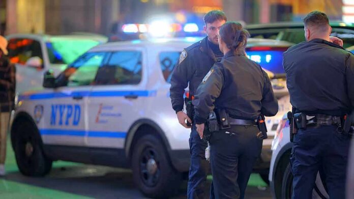 shutterstock_2269104999 police officers standing near patrol vehicles