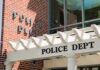 Police department entrance with pergola and brick wall
