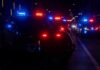 Teen Gunman Terrorizes Halloween Crowd Police vehicles with flashing red and blue lights at night