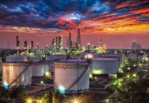 G7 Unleashes 100 Million Oil Barrels Oil refinery with storage tanks at sunset