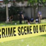 crime scene tape cordoning off a grassy area
