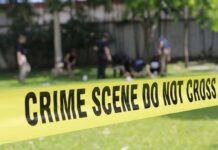 Long Island Park Hides Haunting Remains crime scene tape cordoning off a grassy area