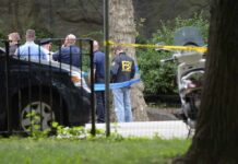 Familicide Alleged After Chilling 911 Call law enforcement officers gather at taped-off outdoor scene