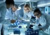 52-Year-Old Murder Case Solved! Scientists collaborating in a laboratory around a microscope