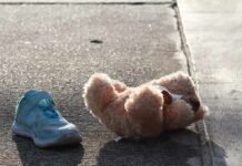 Three-Day Blitz Finds 34 Missing Kids Teddy bear and single blue sneaker on a sidewalk