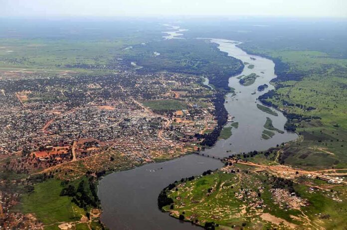 shutterstock_79424332 Aerial view of a river winding through a town and green fields